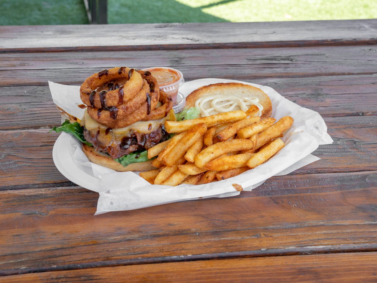 California burger stacked with onion rings, bacon and cheese